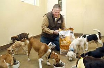 Greg Shearson, CEO of Merrick, feeds dogs at PAWS Chicago.