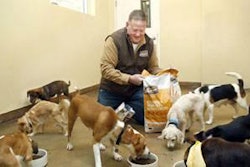 Greg Shearson, CEO of Merrick, feeds dogs at PAWS Chicago.