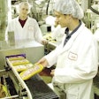 Colin Usher, research scientist and project director, feeds a tray pack package to Georgia Tech’s automatic inspection system as co-op student, Parker McGee, looks on. The system is currently undergoing a field trial at a Fieldale Farms’ processing plant. Installed beside a conveyor that handles the output of packages from several sealing machines, the system is being evaluated for its accuracy in identifying defects – such as film tears – in the seals of packages.