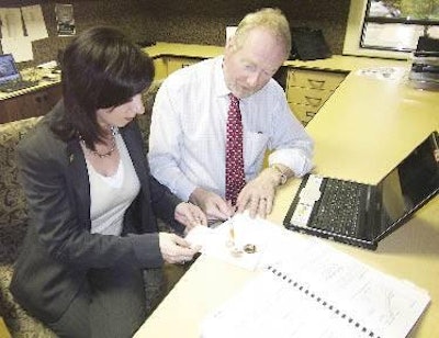 Dr William Close discusses aspects of the interactive benchmarking program with Orla McAleer, Alltech's marketing manager for the Asia-Pacific region.