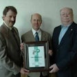 Greg Watt (center), president and CEO of WATT, receives a plaque recognizing WATT’s 35 years of exhibiting at the Midwest Poultry Federation Convention. Presenting the plaque on behalf of the Midwest Poultry Federation are Steven H. Olson, executive director, and Pete Rothfork, president.
