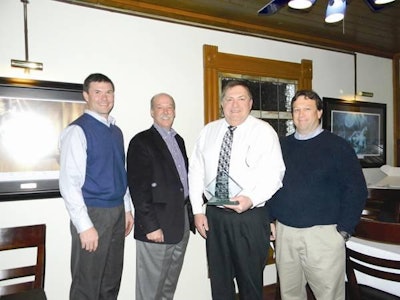 Diamond V Dairy Field Technical Specialist Tom Oelberg, Ph.D., (2nd from right) receives the Diamond V President’s Award from John Bloomhall, Diamond V President and CEO (2nd from left); Curtis Harms, DVM, Diamond V Central Region Manager (far left); and Gerald Poppy, DVM, MBA, Diamond V Director of North American Dairy (far right).