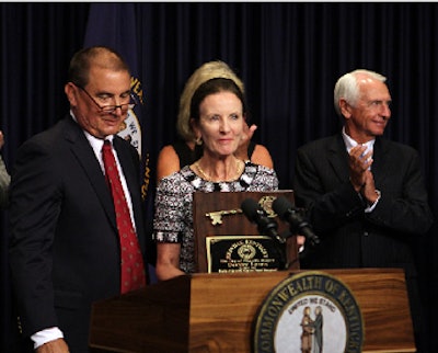 Alltech's Deirdre Lyons accepts a symbolic key to the city from Pikeville, Kentucky Mayor Frank Justice, left. Kentucky Gov. Steve Beshear, right, announced nearly $6 million in funding for the development of an industrial park in eastern Kentucky, where Alltech has committed to building aquaculture and layer facilities. (Photo courtesy of Kentucky Office of Creative Service)