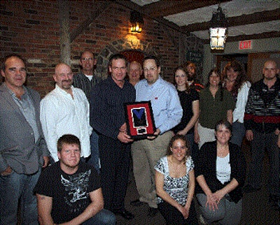 Synergy production manager, Gary McAleer, accepts the award for top Cobb500 performance in Canada from Cobb’s David Engel.