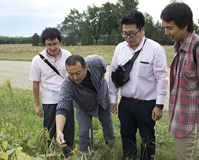 USSEC Soybean Meal Japan Swine Training course participants inspect the field at Bob Haselwood’s soybean farm near Berryton, Kansas.