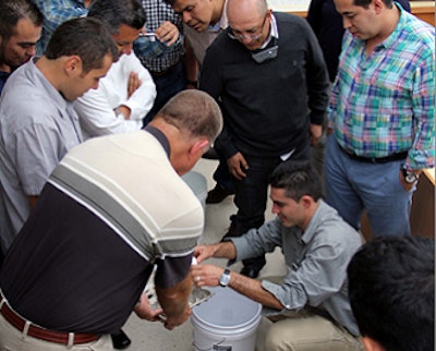The RAPCO Poultry course participants work through an experiment to determine egg-specific gravity.