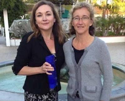 Dr. Shelly Mckee, left, was awarded the Novus Teaching Award from Mercedes Vasquez of Novus International.