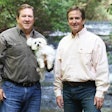 Jeff and Tommy Gay (seen here with Maltese Toby and Yellow Lab Chessie), brothers and co-founders of Big Creek Foods and the Look Who's Happy brand, aim to reach the top of the premium pet treats market with in-house production and the highest quality ingredients. | Courtesy Look Who's Happy