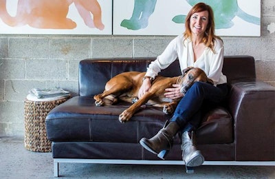 Courtesy The Honest Kitchen | The Honest Kitchen Founder and CEO Lucy Postins, here with Rhodesian Ridgeback Willow, has grown her company from its origins as an online, home-based business to a family-owned business focusing on expanding in the dehydrated pet food market.