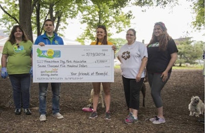 Matt Basler (left) of the Beneful team presents Secretary of the Board of Directors of the Frenchtown Dog Park Association Sarah Gartland (right) with a $7,500 donation to further park improvements at the dog park near downtown St. Louis. | courtesy Purina Beneful