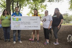 Matt Basler (left) of the Beneful team presents Secretary of the Board of Directors of the Frenchtown Dog Park Association Sarah Gartland (right) with a $7,500 donation to further park improvements at the dog park near downtown St. Louis. | courtesy Purina Beneful