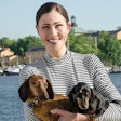 Hugo & Celine CEO Sonja Catani poses in Sweden with the company’s namesakes, Hugo (a brown Mini Dachshund) and Celine (a black and tan Toy Dachshund). | Helene Stevenberg