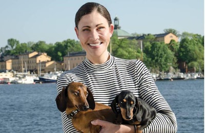 Hugo & Celine CEO Sonja Catani poses in Sweden with the company’s namesakes, Hugo (a brown Mini Dachshund) and Celine (a black and tan Toy Dachshund). | Helene Stevenberg