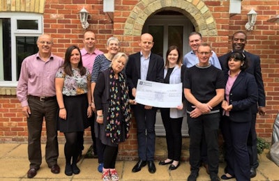 European poultry industry leaders present a check to Honeypot Children's Charity. | Grayling