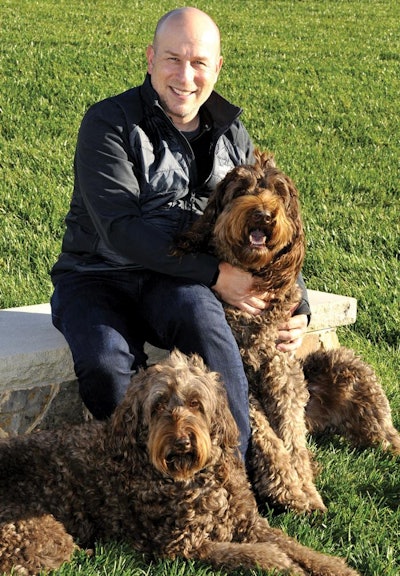 Solid Gold CEO and President Bob Rubin, here with Labradoodles Toby and Moose, has re-focused the company’s brand and message since taking the helm in 2015. | Courtesy Solid Gold Pet