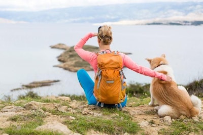 Woman Backpacking With Dog