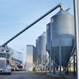 Remote-controlled booms increase biosecurity by allowing the truck operator to unload feed while inside the cab. | Walinga Inc.