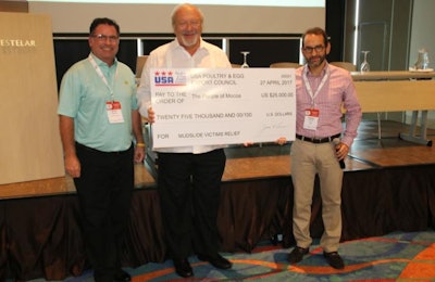 USA Poultry & Egg Export Council Chairman Steve Monroe, left, and President Jim Sumner, center, present a check for $25,000 for flood relief efforts in Moccoa, Putumayo, Colombia. | USAPEEC