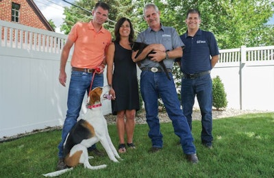 Best Breed Vice President Levi Wittenmyer, Dr. Toni Cotton, DVM, Founder Dr. Gary Cotton, DVM, and President Kent Benson, here with American Foxhound mix Walter and black cat Barney, focus on natural and holistic formulations to provide the best nutrition available to pets. | Courtesy Best Breed