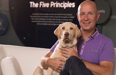 Since becoming regional president of Pet Nutrition North America, Mars Petcare, Mark Johnson (shown with Hoover, the dog of a Mars associate) has focused on connecting with consumers and retail customers. l Courtesy of Mars Petcare