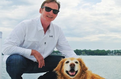 Isle of Dogs President John Hart, here with his Golden Retriever Indy, has married external pet beauty with internal pet health while expanding his business. | Photo courtesy Isle of Dogs