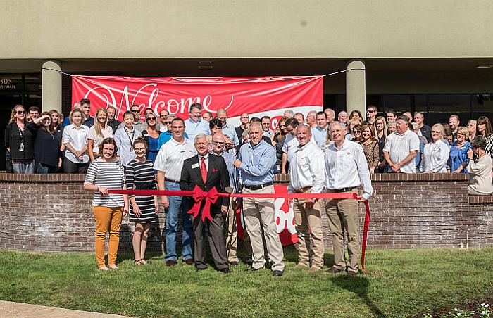 Cobb-Vantress President Joel Sappenfield cuts the ribbon in front of the company&rsquo;snew office location in downtown Siloam Springs, Arkansas. | Photo courtesy of Cobb-Vantress
