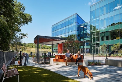 A key feature of Mars Petcare North America’s new pet-friendly headquarters is a dog park, outfitted with tables and chairs, plus wifi, so associates can work while their dogs romp. l Hall + Merrick Photographers, courtesy of Mars Petcare