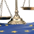 Scales of justice and Flag of European union European union law concept.