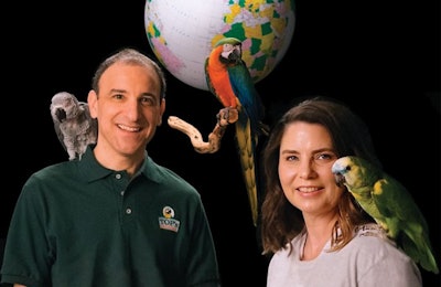 TOP’s Parrot Food Co-owners Gary Rubin and Kristen Ertischek pose with a few of their brightly colored customers: Ernie the Congo African Grey, Sebastian the Catalina Macaw, Chaco the Blue Front Amazon and Sancho the Green Wing Macaw. | Photo by Pedro Peraza, courtesy TOP’s Parrot Food | Birds courtesy Exotic Bird Rescue of Oregon