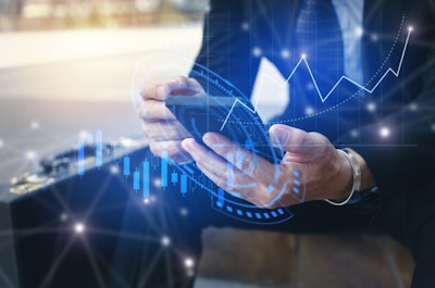Young Investor Or Business Man Using Mobile Phone With Graphic G