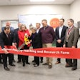 Iowa State University President Wendy Wintersteen and Arlene Hamilton cut the ribbon at the dedication ceremony of the Iowa State University Robert T. Hamilton Poultry Teaching and Research Farm on March 5. (Deven King)