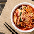 Kimchi cabbage in a bowl with chopsticks (Buppha Wut, Bigstock.com)