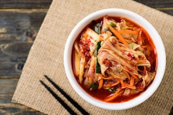 Kimchi cabbage in a bowl with chopsticks (Buppha Wut, Bigstock.com)