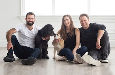 Open Farm co-founders Derek Beigleman, Jacqueline Prehogan and Isaac Langleben, here with Golden Retriever mix Molly and Puggle Bella, wants to lead the pet food industry towards sustainability by changing the way pet food is sourced and produced. | (Courtesy Open Farm)