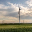 Wind Turbine In Wheat Field In Sunset. Sustainable Energy. Susta