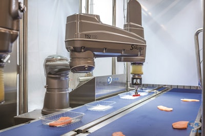 Caption: Picking robots need to reliably discern and collect objects of differing size, weight and shape rapidly moving down a belt while handling the work environment and sanitation. (Jordan Fowler Videography)