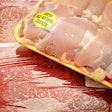 Packaged meat at the market; boneless chicken thighs and beef cube steaks..** Note: Shallow depth of field