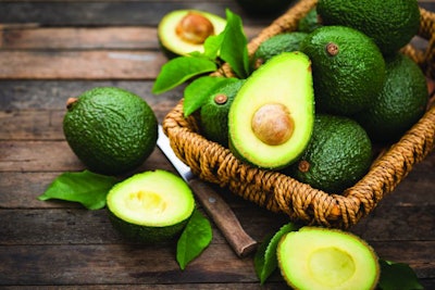 Fresh organic avocado on the wooden table