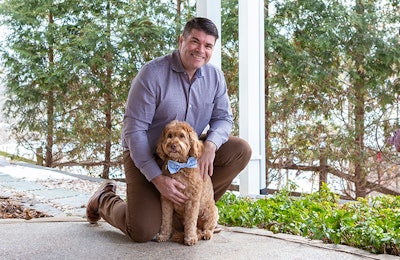 Compana Pet Brands CEO John Howe, seen here with Goldendoodle Bear, has been with the company for 22 years and in that time has seen the company grow significantly. | Courtesy Compana Pet Brands