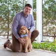Compana Pet Brands CEO John Howe, seen here with Goldendoodle Bear, has been with the company for 22 years and in that time has seen the company grow significantly. | Courtesy Compana Pet Brands
