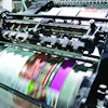 Detail shot of the workings of a printing factory. The commercial designs displayed in this image represent a simulation of a real product and have been changed or altered enough by our team of retouching and design specialists so that they are free of any copyright infringements