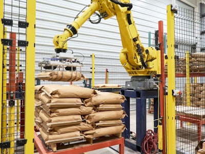 A JEM International robot stacks bags of feed on pallets at the Feed Technology Center. (Ann Reus)