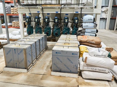 Ingredients from the micro bins in the warehouse are conveyed to the mixer using a Cablevey conveyor system. (Ann Reus)