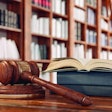 Law books and a gavel on the desk in the library.