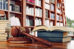 Law books and a gavel on the desk in the library.