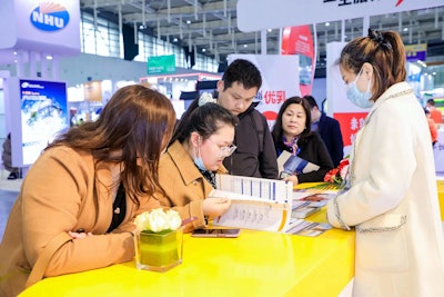 The U.S. Grains Council's (USGC's) staff in China recently welcomed China Feed Industry Expo visitors to the Council's booth to learn more about the Council's work, while getting to better know the needs of Chinese customers. Pictured, Linda Li (right), USGC ethanol programs coordinator in China, talked with expo attendees.