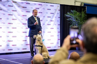 North Carolina State Senator Phil Berger and his dog, Obi, address the crowd at the grand opening of the new Purina pet food factory in Eden, North Carolina.
