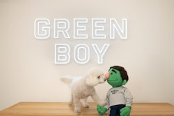 Bean, the Green Boy mascot, and his friend, Junior, celebrate the opening of Green Boy Groups Pet Food Division on April 1.