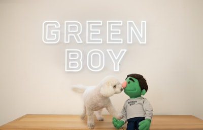 Bean, the Green Boy mascot, and his friend, Junior, celebrate the opening of Green Boy Groups Pet Food Division on April 1.