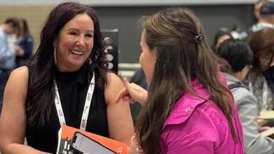 Tamara Ghandour chats with an attendee during her book signing at Petfood Forum in Kansas City on Wednesday, May 1.